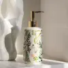 97906-8c6dd8.webp Elegant Ceramic Flower Soap Dispenser