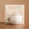 98669-68b6b9.webp Gilded Silver Ceramic Teapot